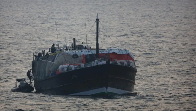 Crew boarding Her Majesty's Australian Ship from from a smaller boat out at sea