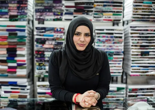 Female Syrian refuge sitting at a desk