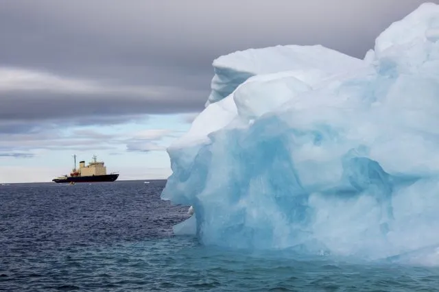 Iceberg with reflection drifting in the arctic ocean
