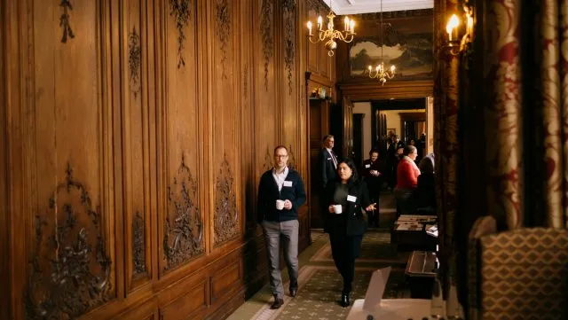Participants walking down a hallway at Wiston House