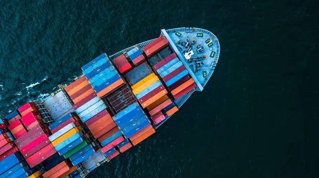 An aerial view of container cargo ship at sea.