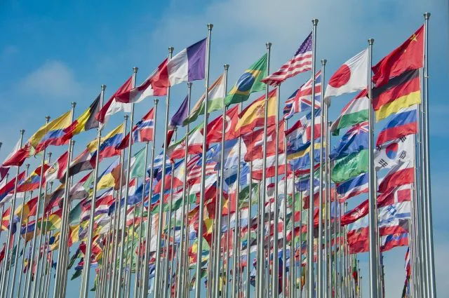 Flags from many nations around the world flying together.