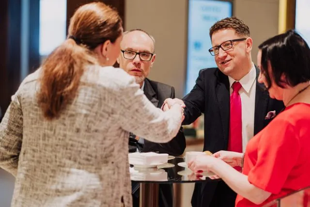 Participants meeting each other at a Wilton Park event