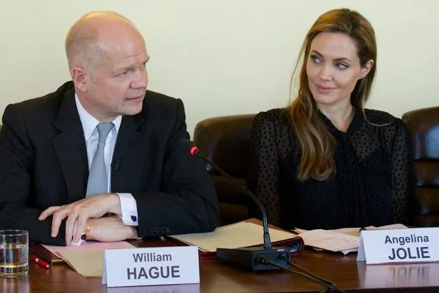William Hague and Angelina Jolie sit at a table at Wilton Park.