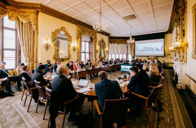 Participants in discussion around the conference table at Wilton Park