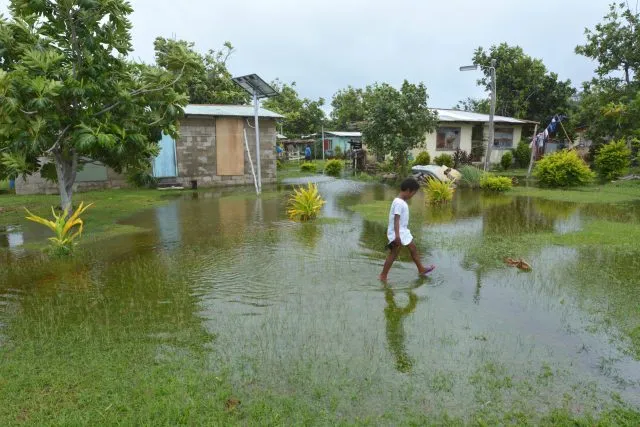 Indigenous Fijian girl walking on flooded land in Fiji. On Feb 2016 Severe Tropical Cyclone Winston was the strongest tropical cyclone in Fiji Islands in recorded history.