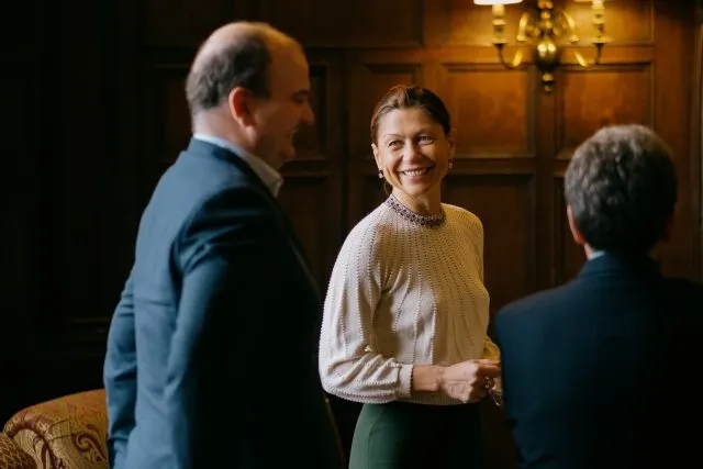 Participants speaking in the margins at a Wilton Park event.