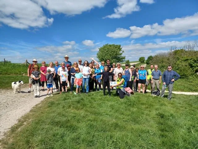 Wilton Park colleagues pose at the top of a hill as they each walk 5km to raise funds for charity.