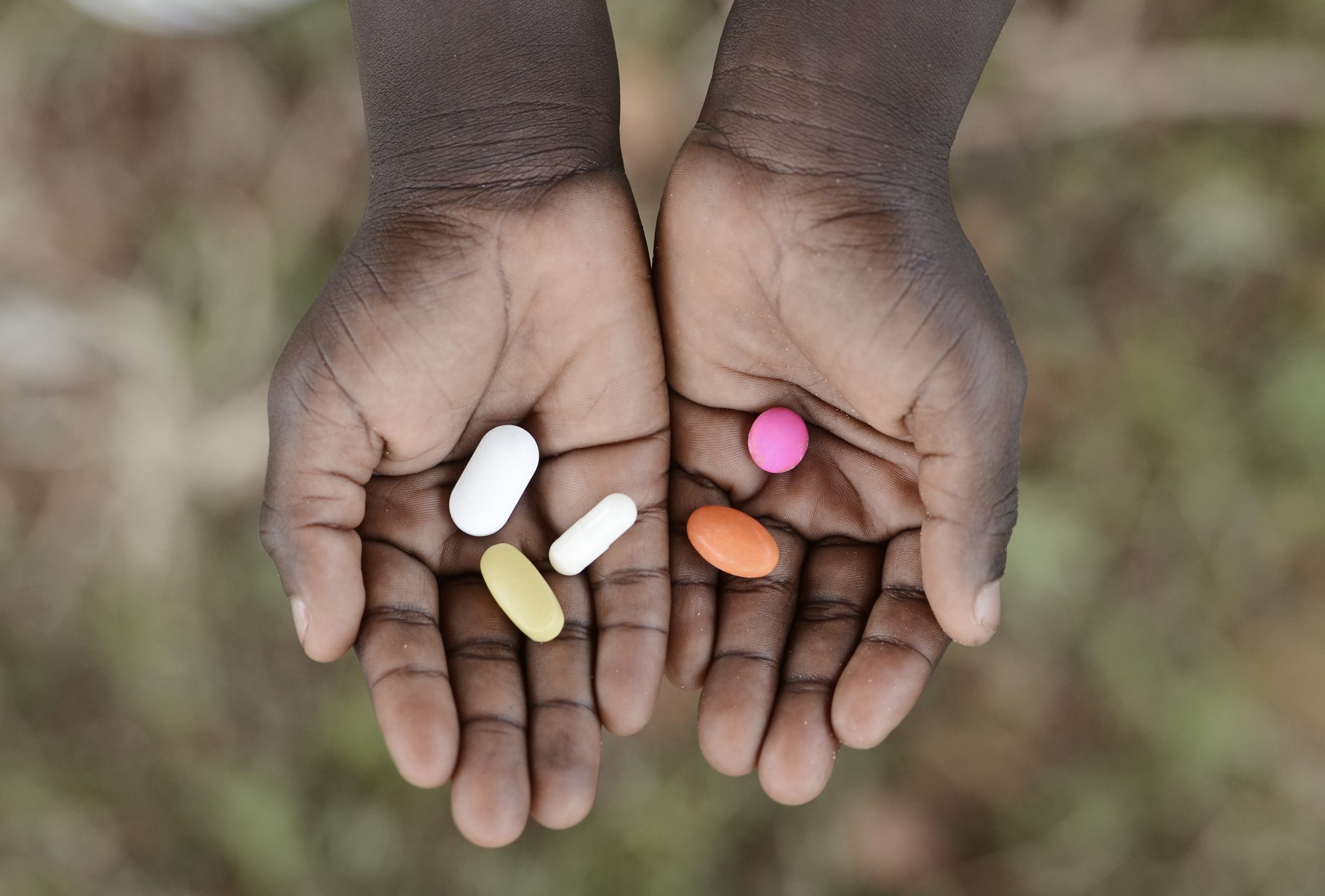 Curing,Malaria,-,African,Girl,Holding,Pills,Medicine,Health,Symbol.