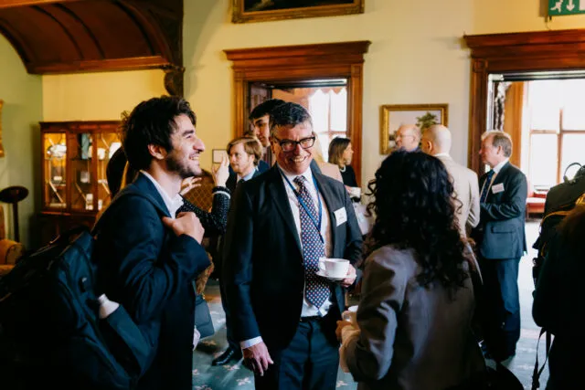 Wilton Park CEO Tom Cargill talks with participants at the Ambassadorial Summit 2024