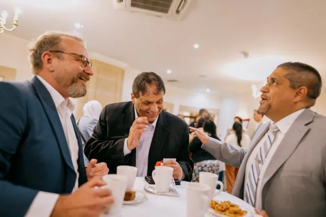Muhannad Alazzeh, Secretary General, the Higher Council for the Rights of Persons with Disabilities, Jordan; and José Viera, Interim Executive Director of the International Disability Alliance, smile as they talk around the tea table