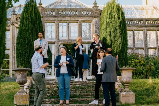 Participants stand on the steps outside the Orangery