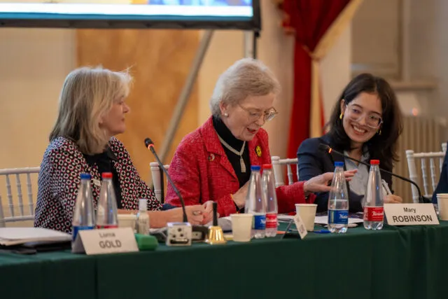 Former President of Ireland and Chair of The Elders Mary Robinson. Wilton Park programme director Alison Hilliard and youth climate activist Ridhima Pandey sit together at the conference table