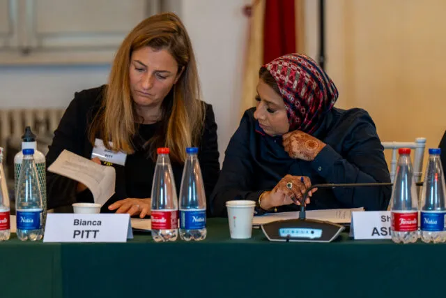 Shahin Ashraf, Head of Global Advocacy at Islamic Relief Worldwide, sits with Bianca Pitt, co-founder of SHE Changes Climate, at the conference table