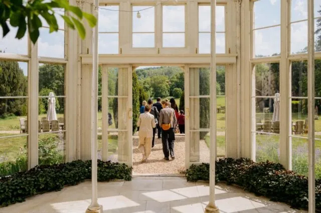 Participants walk into the gardens from the Orangery