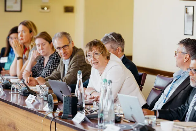 Catherine Royle, political advisor at NATO, speaks at the conference table