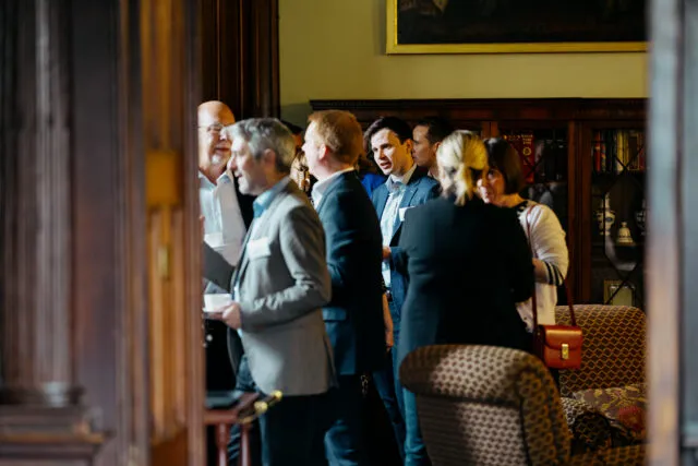 Participants talk in the Common Room