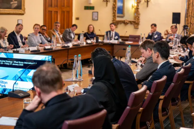 Participants seated around the conference table