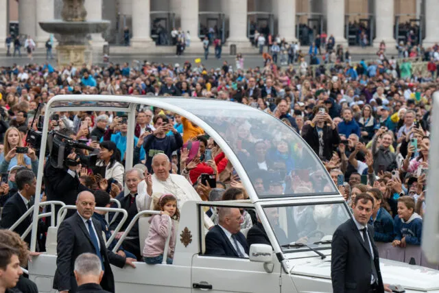 Pope Francis addresses the crowds in St Peter's Square from the Popemobile