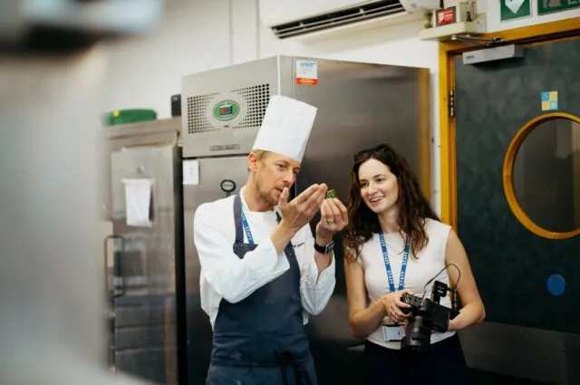 Wilton Park content producer Gaby Russell talks to one of the Wilton Park chefs in the kitchen