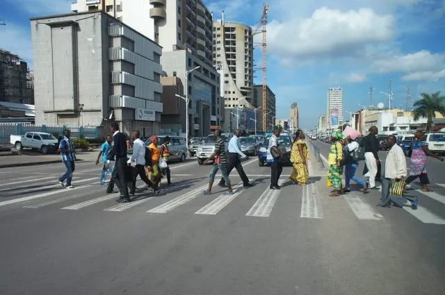 A group of people crossing a zebra crossing in Kinshasa