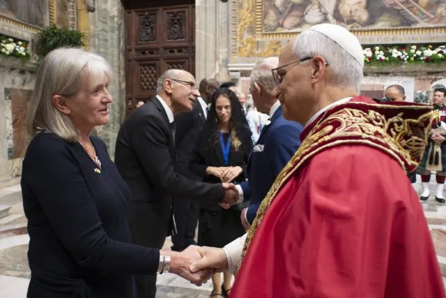 Wilton Park senior programme director Alison Hilliard shakes hands with Pope Leo XIV