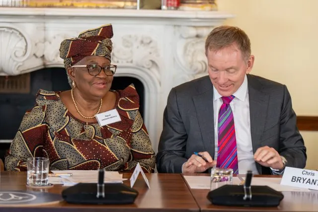 Dr Ngozi Okonjo-Iweala, Director-General of the World Trade Organisation, sits with Sir Chris Bryant MP, Minister of State at the Department for Business and Trade, at the conference table.