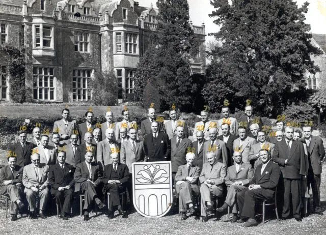 Attlee and Beveridge pose for a group photo at a Wilton Park event in 1956.