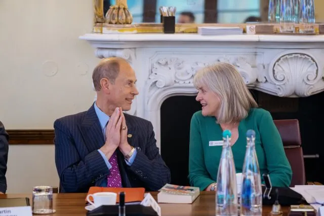 HRH The Duke of Edinburgh and Wilton Park Senior Programme Director sit together at the conference table