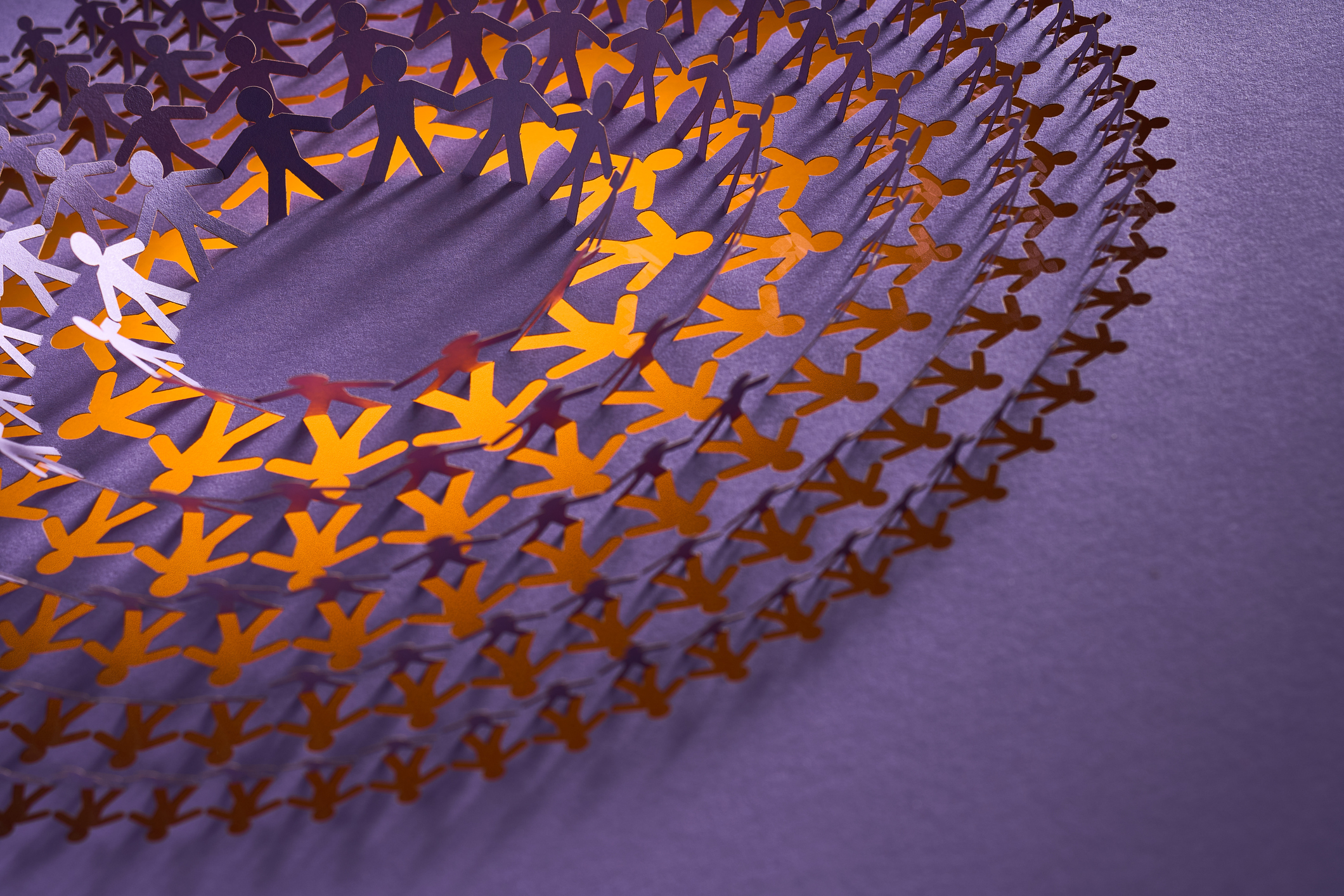 Detailed Paper Cut Artwork of Human Figures with Gradient Colors from Orange to Purple on Purple Background