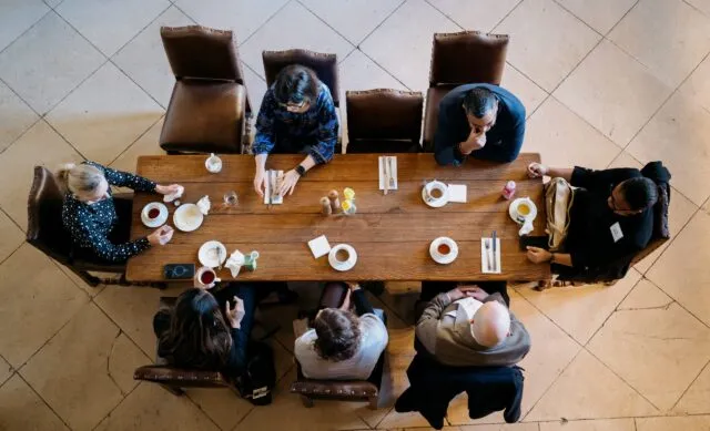 An overhead view of participants seated at a dining table in the Great Hall