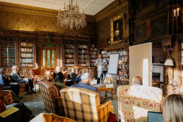 Participants seated in armchairs for a breakout group in the Library