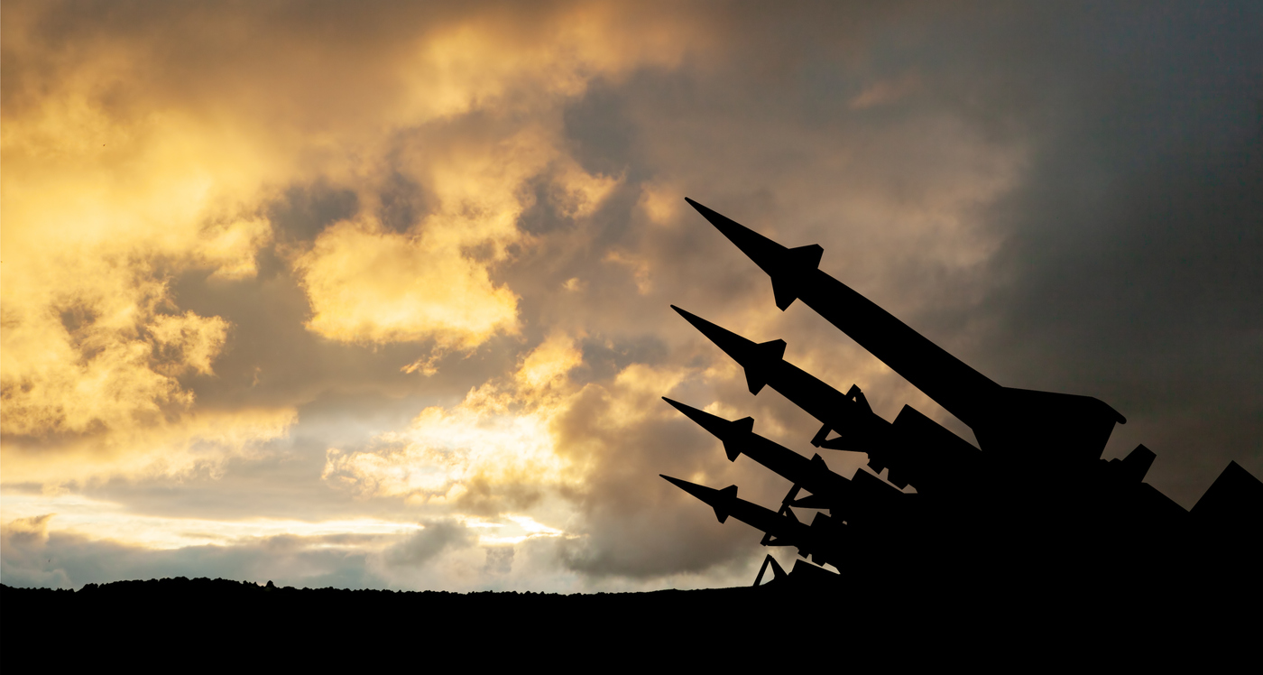 The missiles are aimed at the sky at sunset.