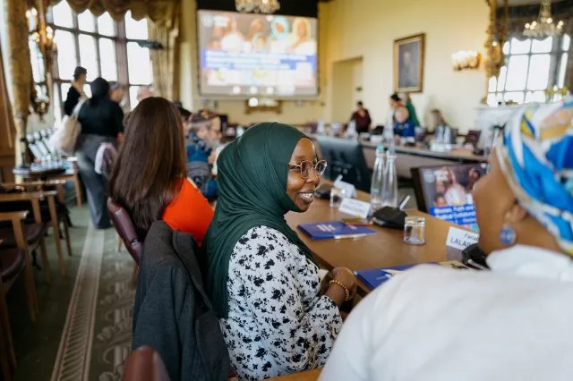 Fariah Laliaikiapan smiles as she sits at the conference table