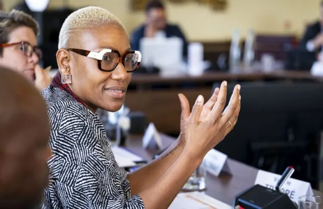 Valerie Traore speaks at the conference table