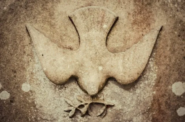 An image of a dove made of stone.