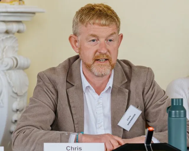 Chris Sherwood speaks at the Wilton Park conference table