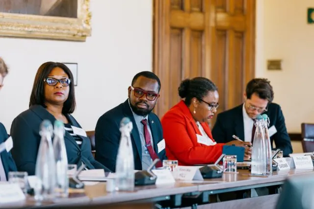 Participants seated along the conference table