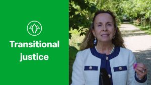 Anna Myriam Roccatello speaks in the grounds of WIlton Park. Text reads: Transitional Justice