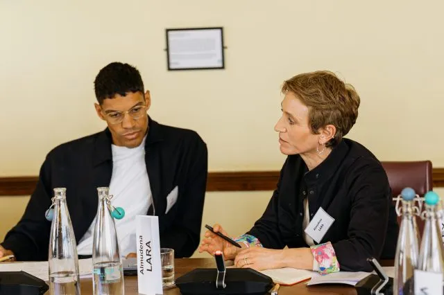 A participant listens as a fellow guest speaks