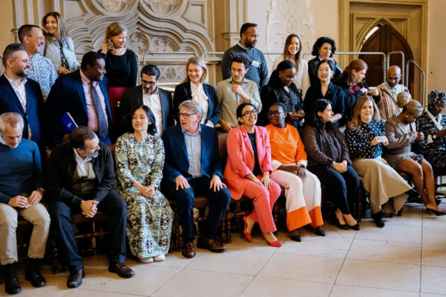 a group of participants gathered for a group photo at a Wilton Park event.