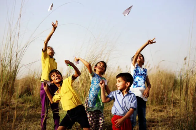 Group of rural children playing outdoor in nature.